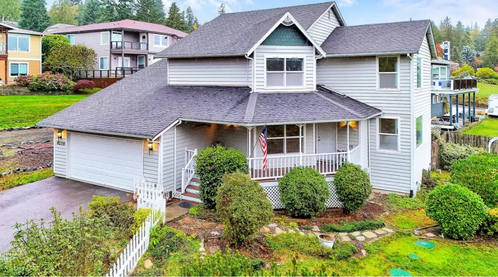 Exterior view of a two-story residential home with front porch and landscaped yard